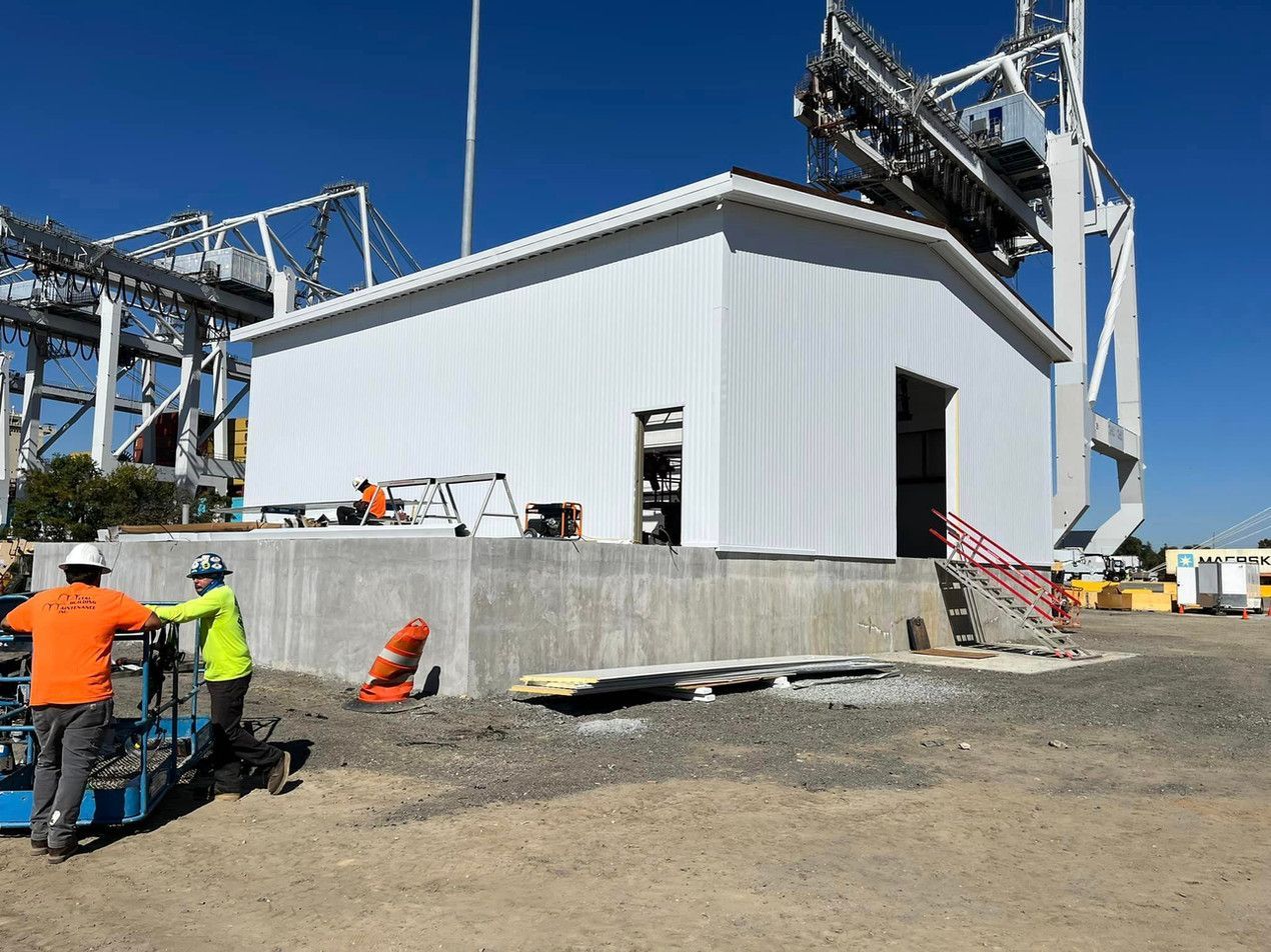A group of construction workers are working on a building.