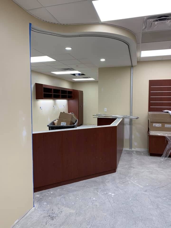 An empty room with a wooden counter and a glass wall