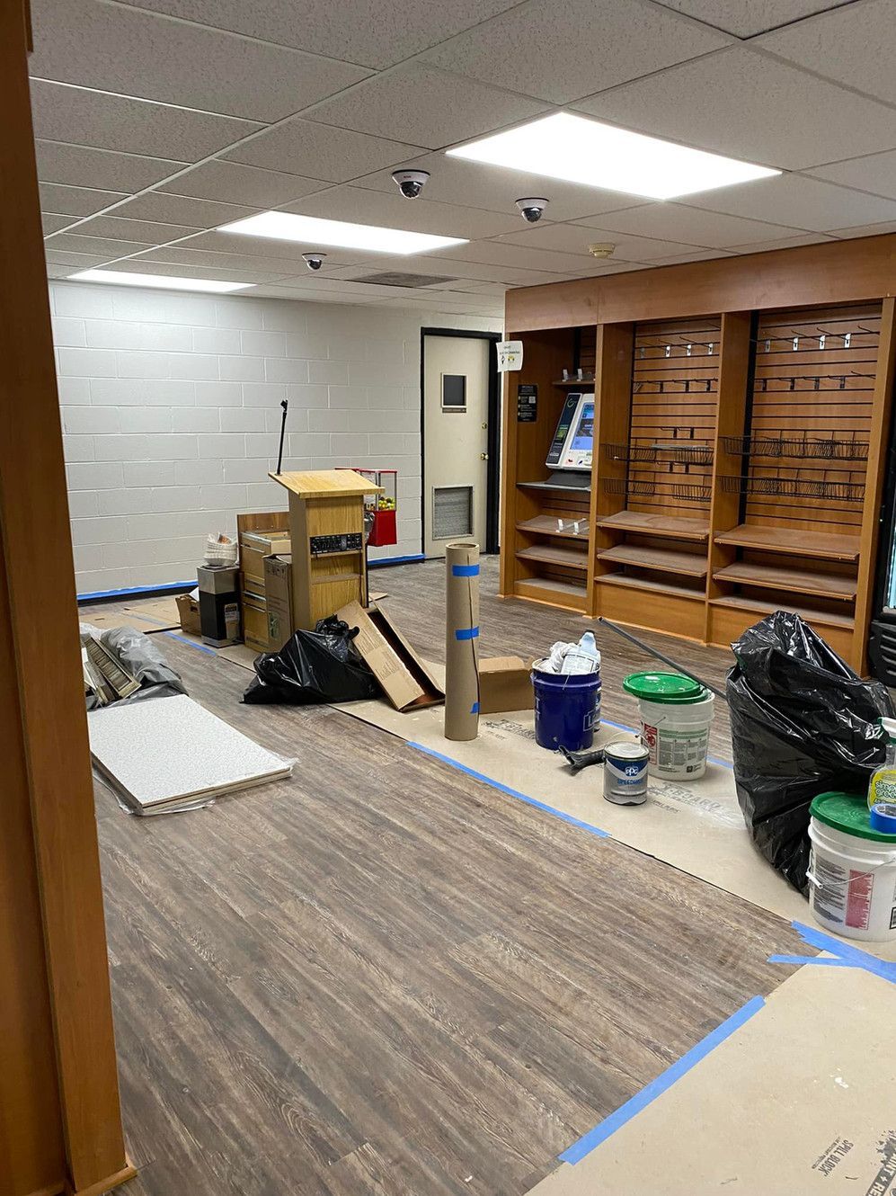 A room with a lot of boxes and trash on the floor.