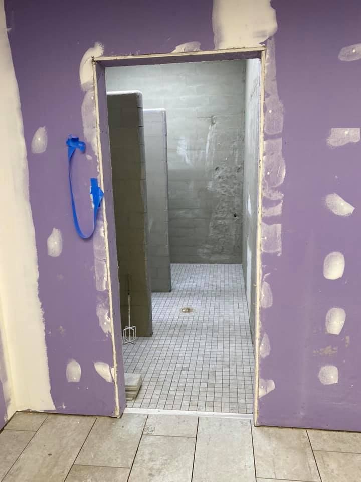 A doorway leading to a bathroom with purple walls