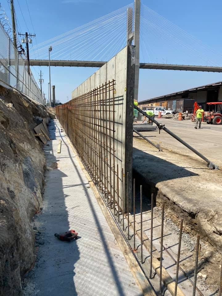 A concrete wall is being built in a construction site.