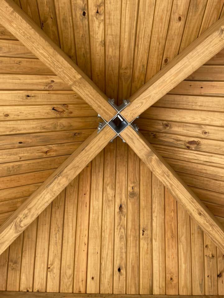 A close up of a wooden ceiling with wooden beams.