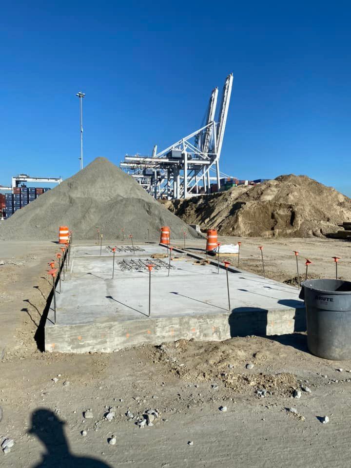 A construction site with a large pile of dirt in the background.