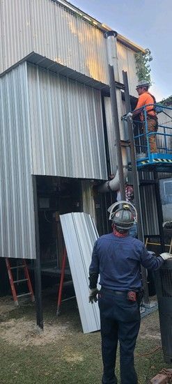 A wooden fence is being built next to a body of water.