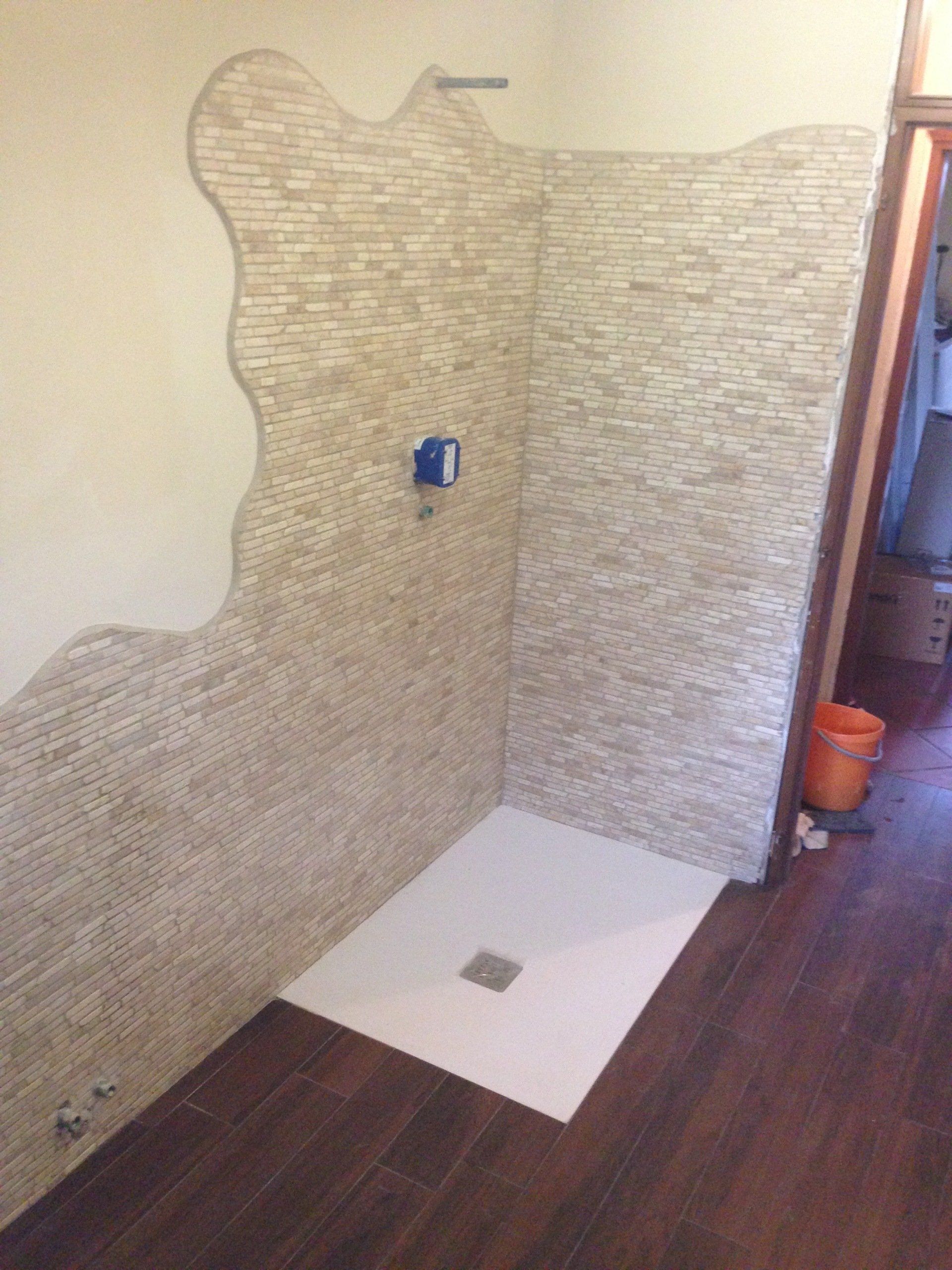 Ristrutturazione bagno con installazione piastrelle su parete