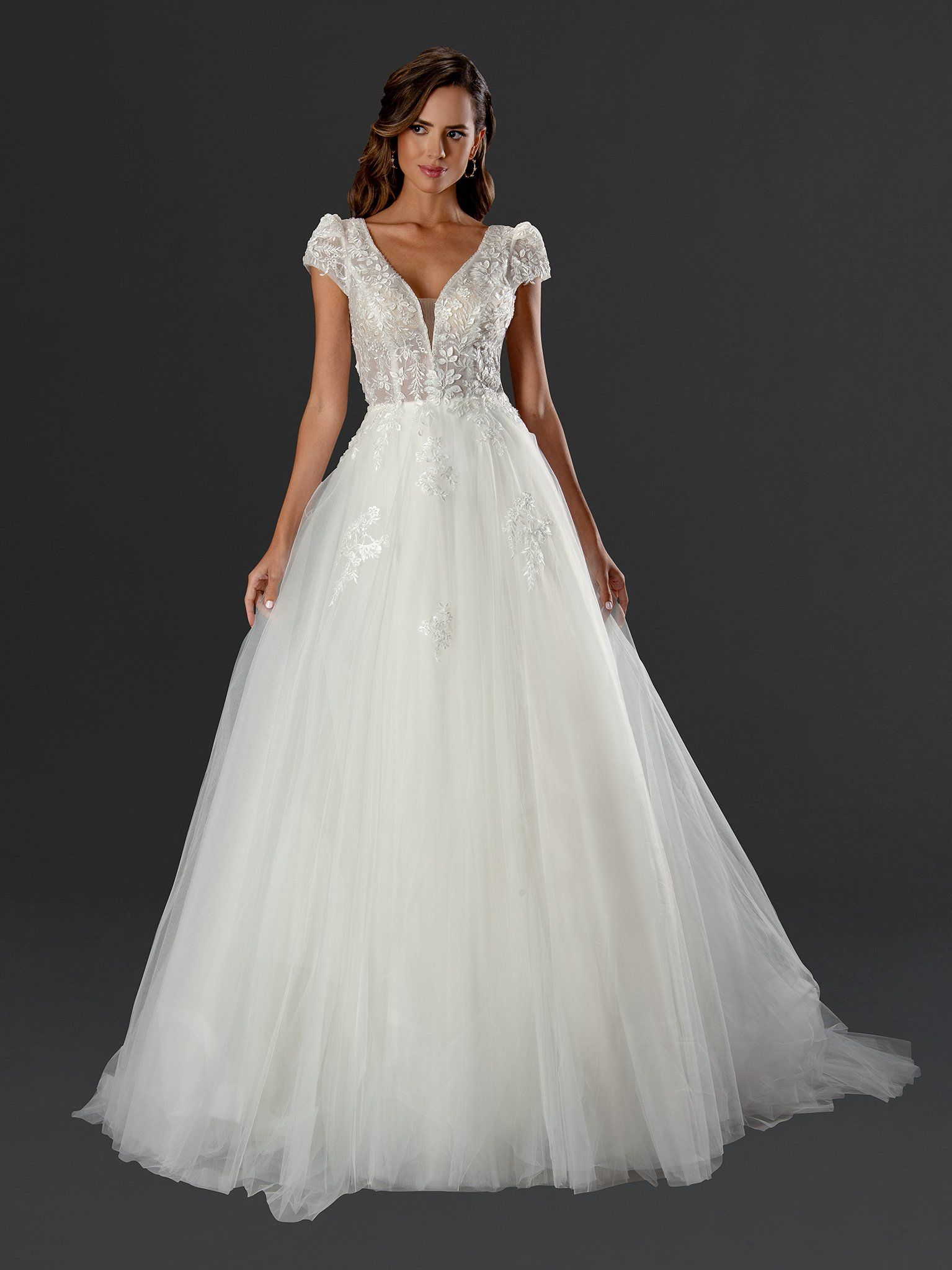 A woman is wearing a white wedding dress with short sleeves.