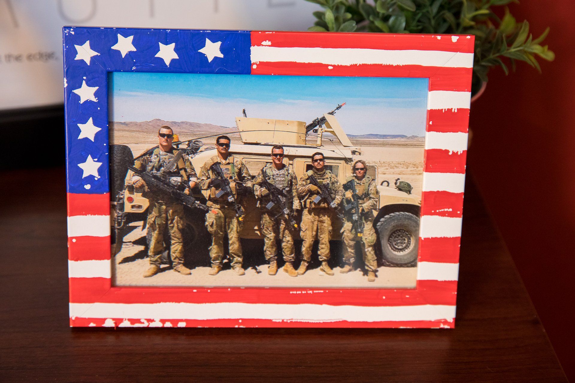 A picture of soldiers in an american flag frame