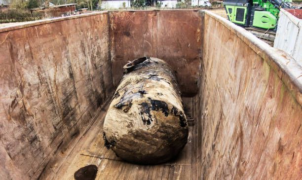 An old rusted tank in an iron container for further proper disposal.