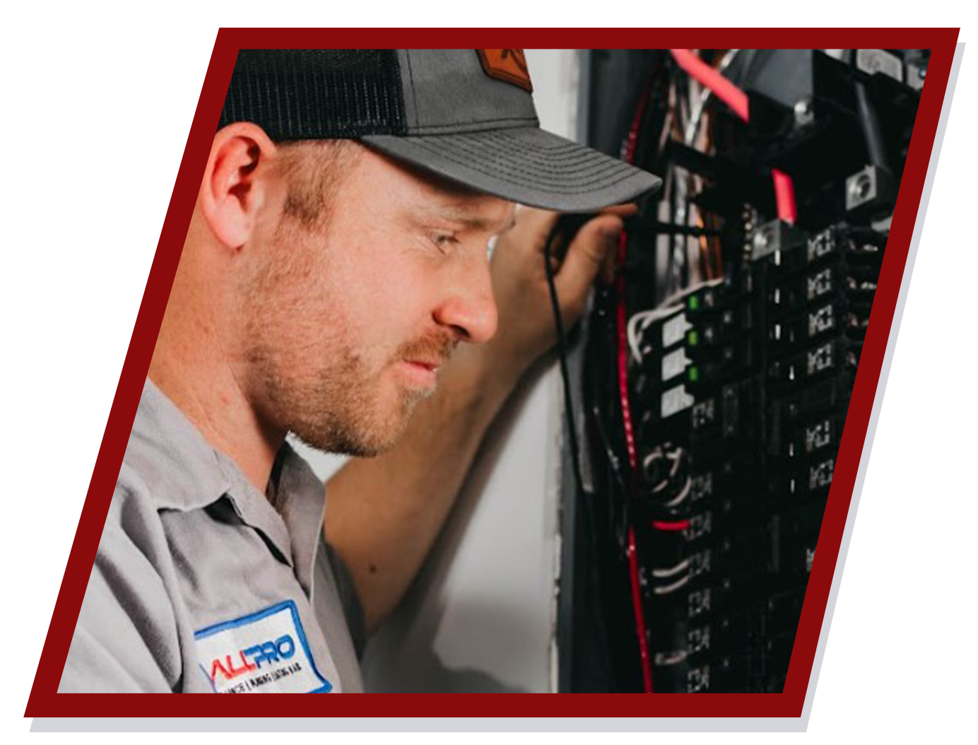 Electrician examining a circuit breaker panel, wearing a cap and work shirt. Electrician examining a circuit breaker panel, wearing a cap and work shirt.