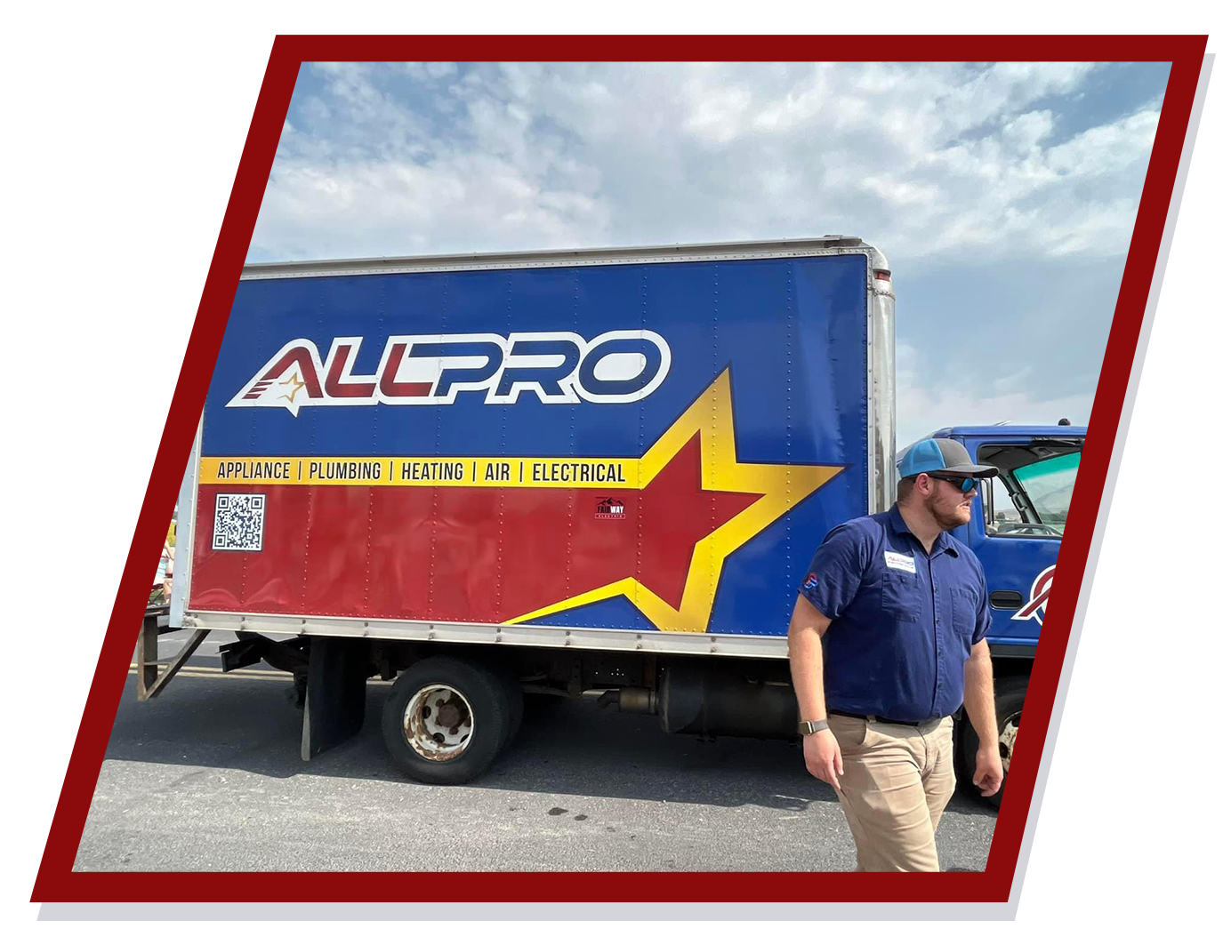 Man in blue shirt near Allpro moving truck, blue and red with a star logo.