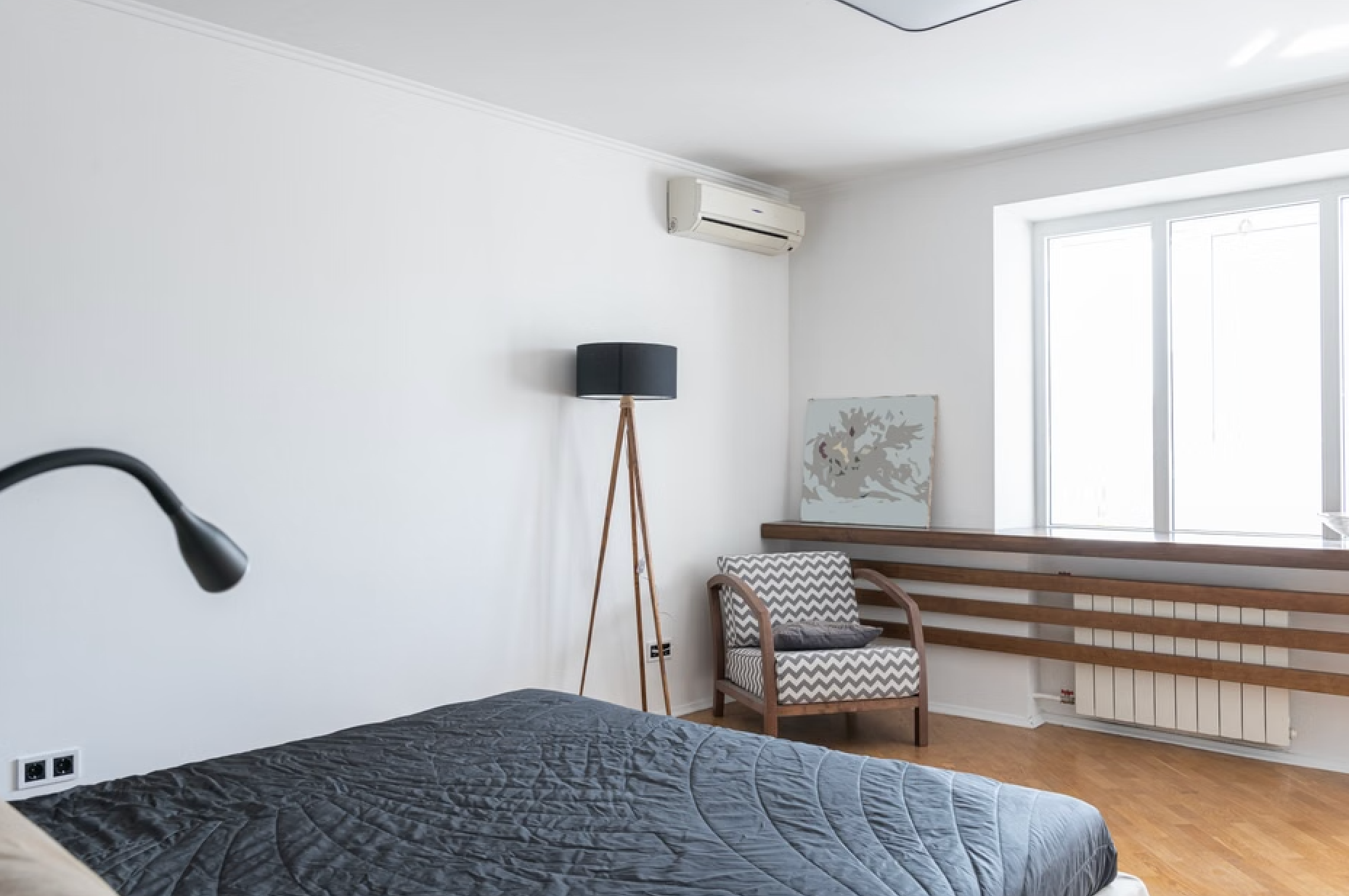 Cozy bedroom with a sleek wall-mounted mini split unit