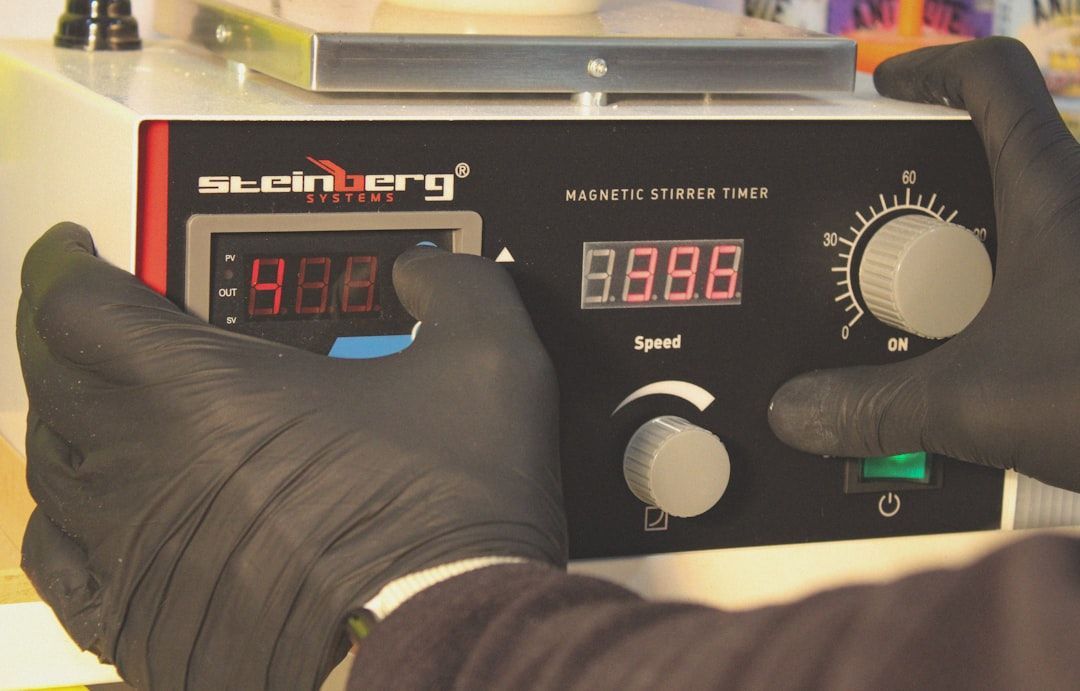 Technician using a specialized pressure gauge to test a backflow assembly - backflow inspection comp