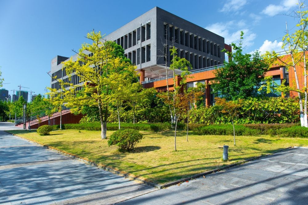 A large building with a lot of trees in front of it.