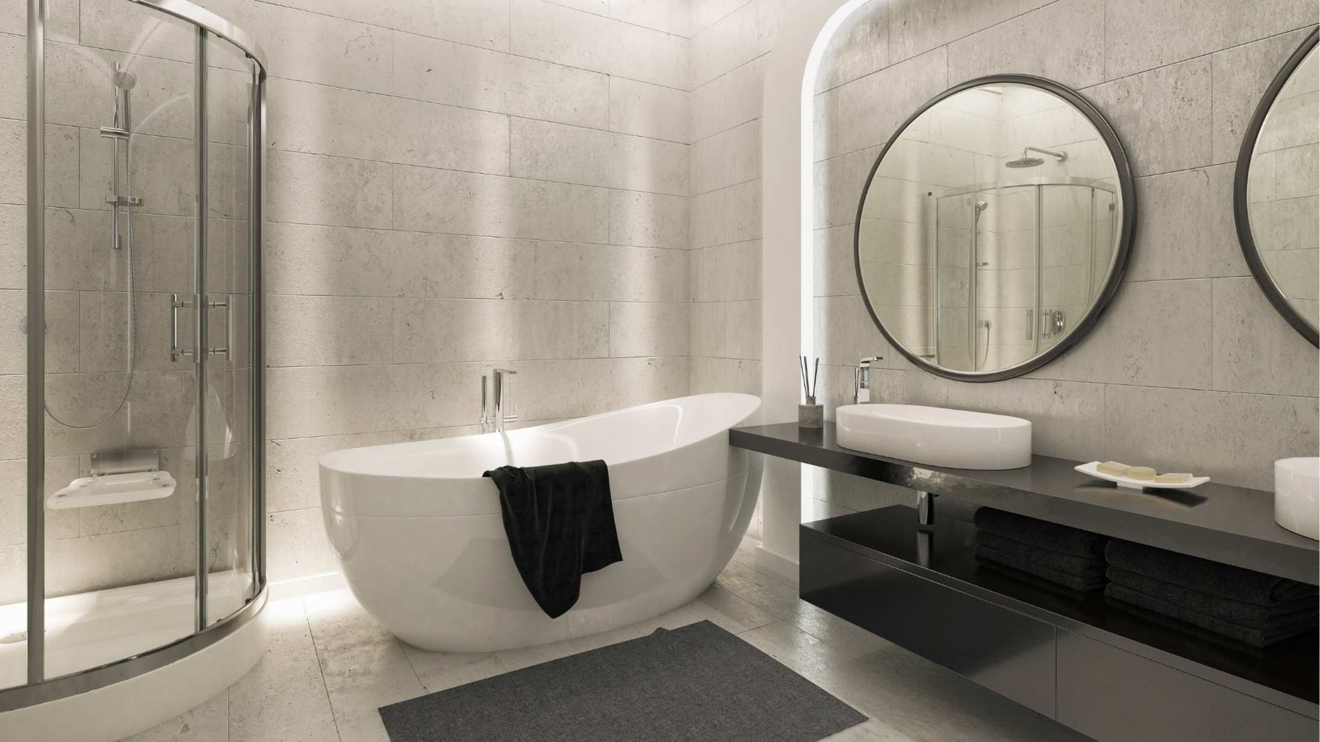 Modern bathroom with freestanding tub, glass shower, double vanity, round mirrors, and black towels