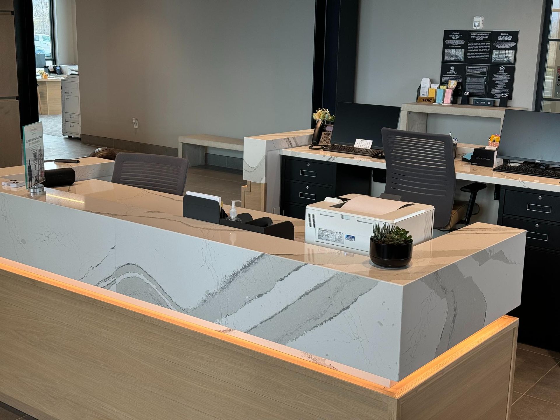 Bathroom vanity with a granite countertop, sink, faucet, and decorative backsplash.