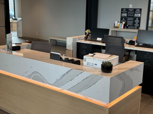 Bathroom vanity with a granite countertop, sink, faucet, and decorative backsplash.
