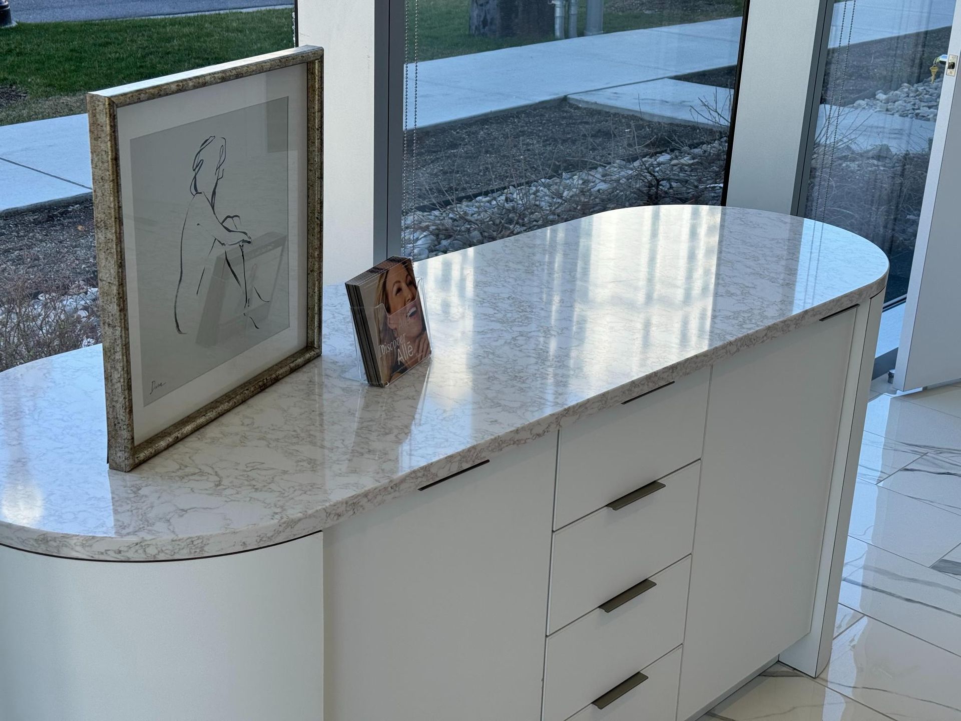 Bar with wooden cabinets, grey countertop, and mosaic backsplash.