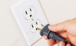 Inserting an electric plug — Electrical Contractor in Glendale, NY