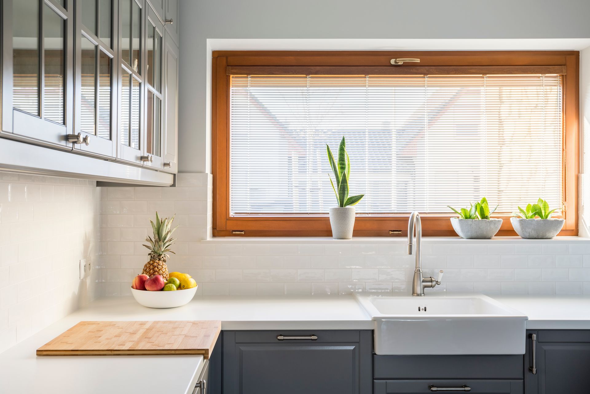 light kitchen with white countertops and large window