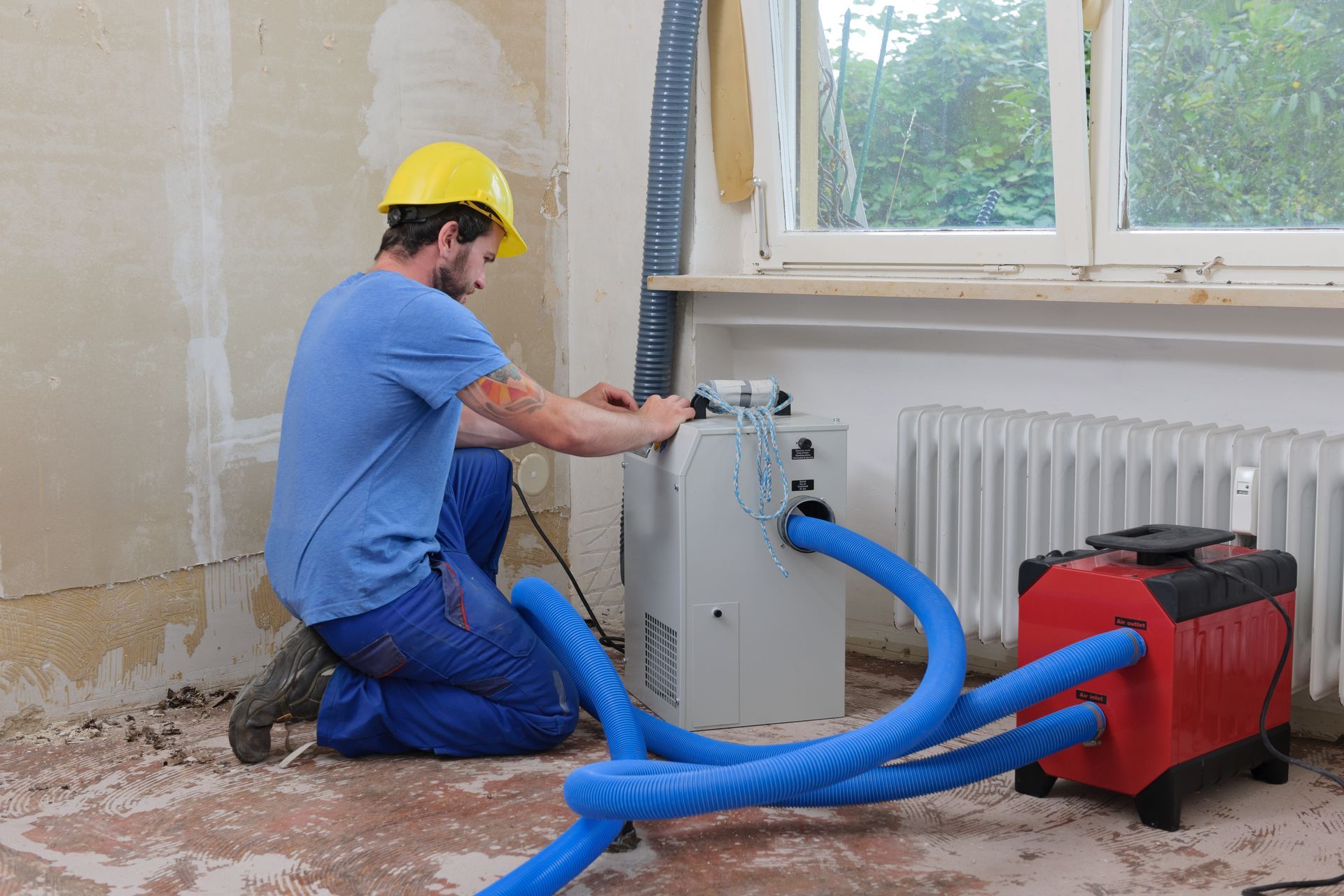 worker adjusting dehumidifier