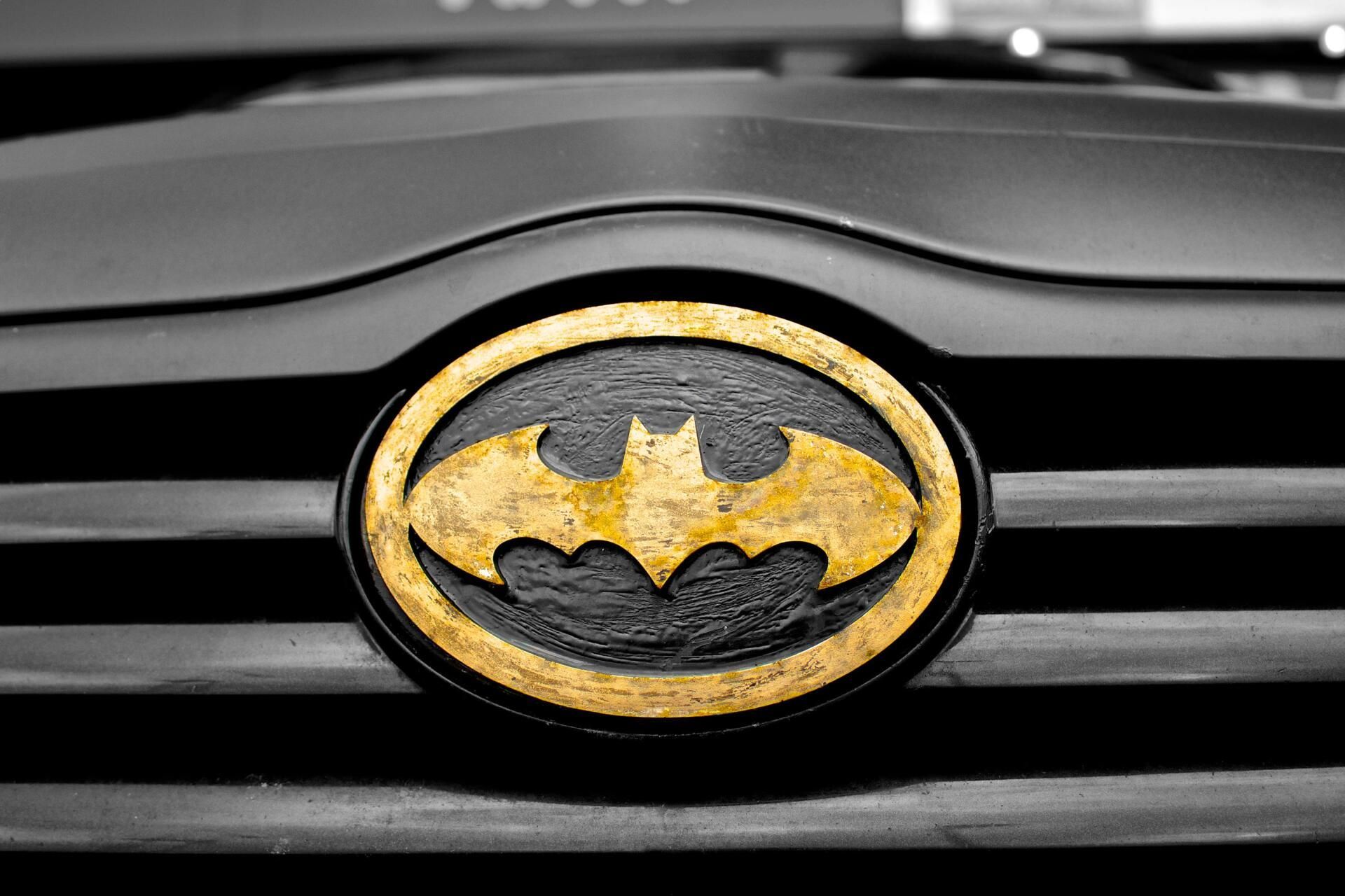 Black car grill with gold Batman logo.