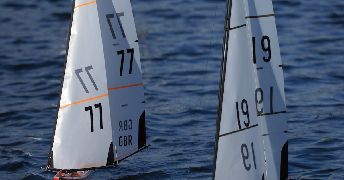 Two sailboats on water; one with 