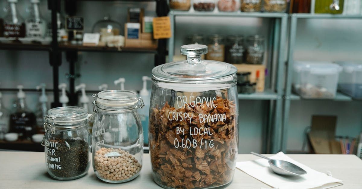 Glass jars of food products on a counter in a shop.