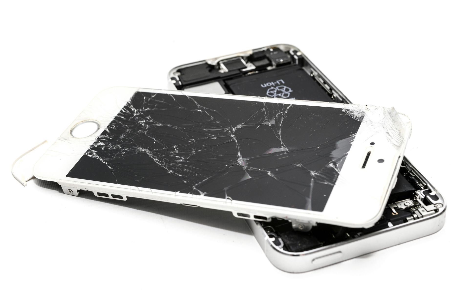 Two white smartphones with severely cracked screens, one on top of the other, against a white background.