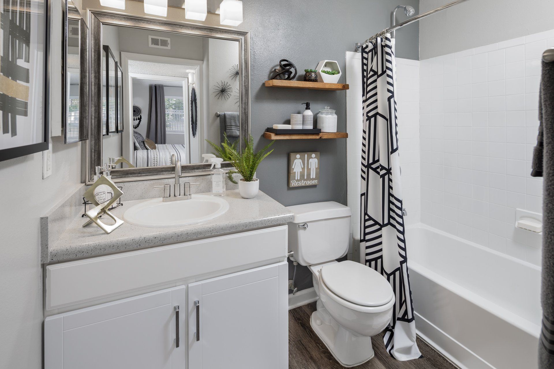 Bathroom with sink, mirror, toilet, and shower at 1801 Metrowest