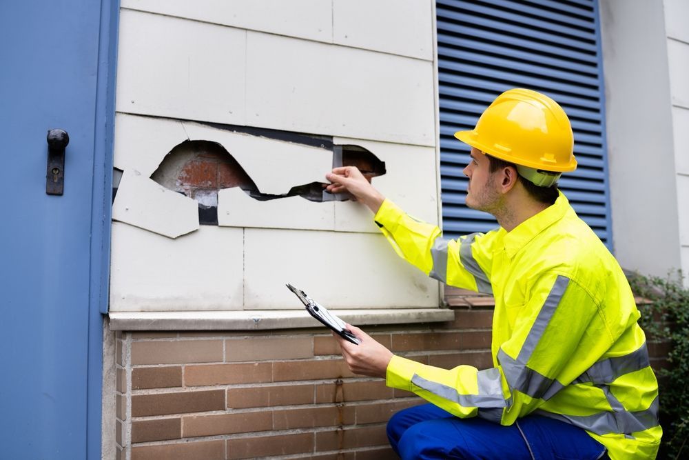 insurance inspector with their paperwork at a property