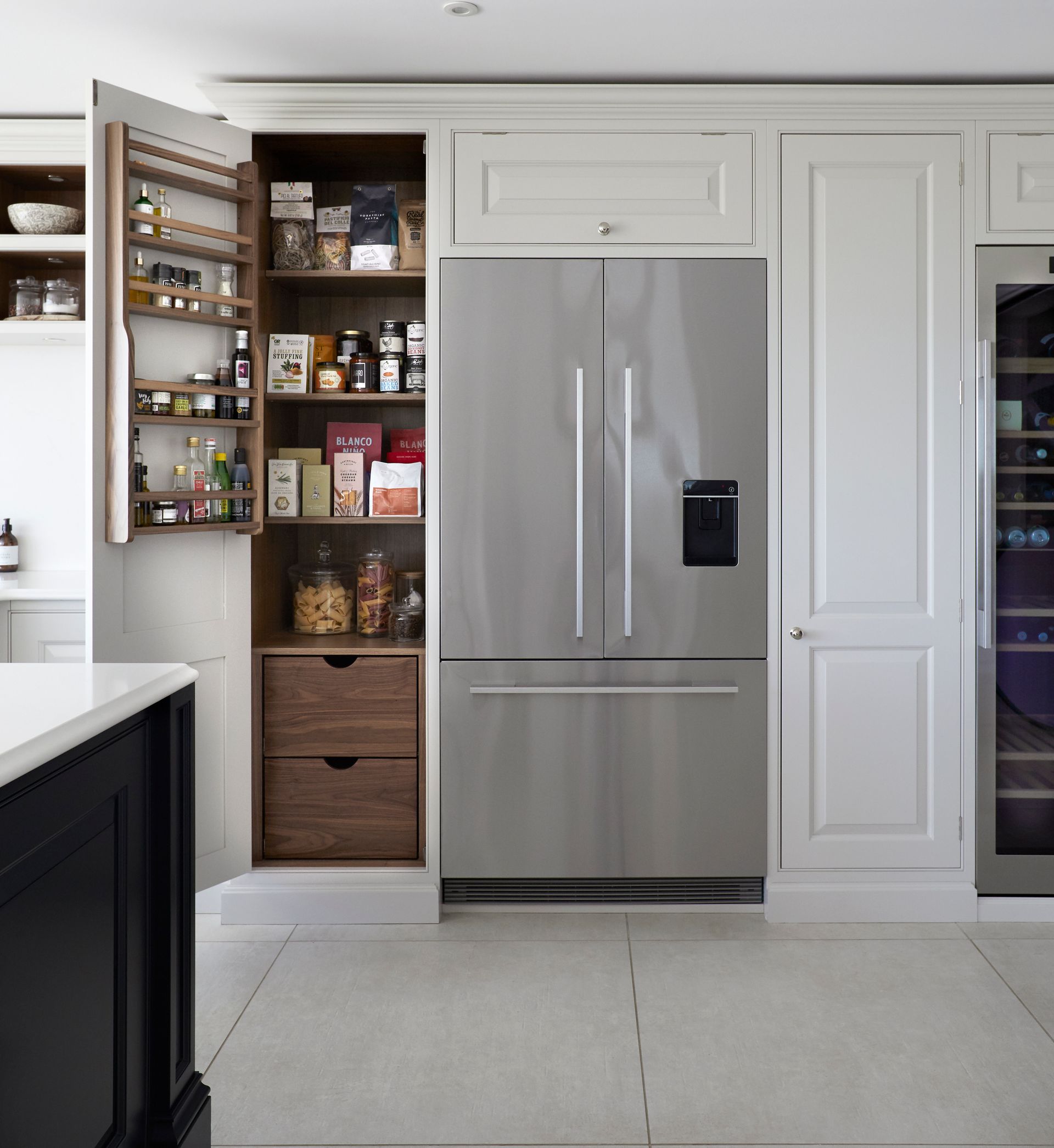 a kitchen with a stainless steel refrigerator and a pantry