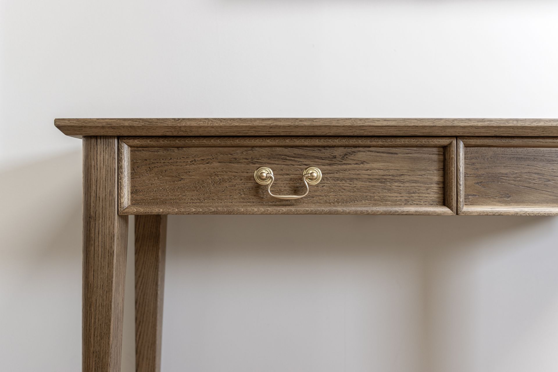 a large painting is hanging on a wall above a green fitted freestanding furniture