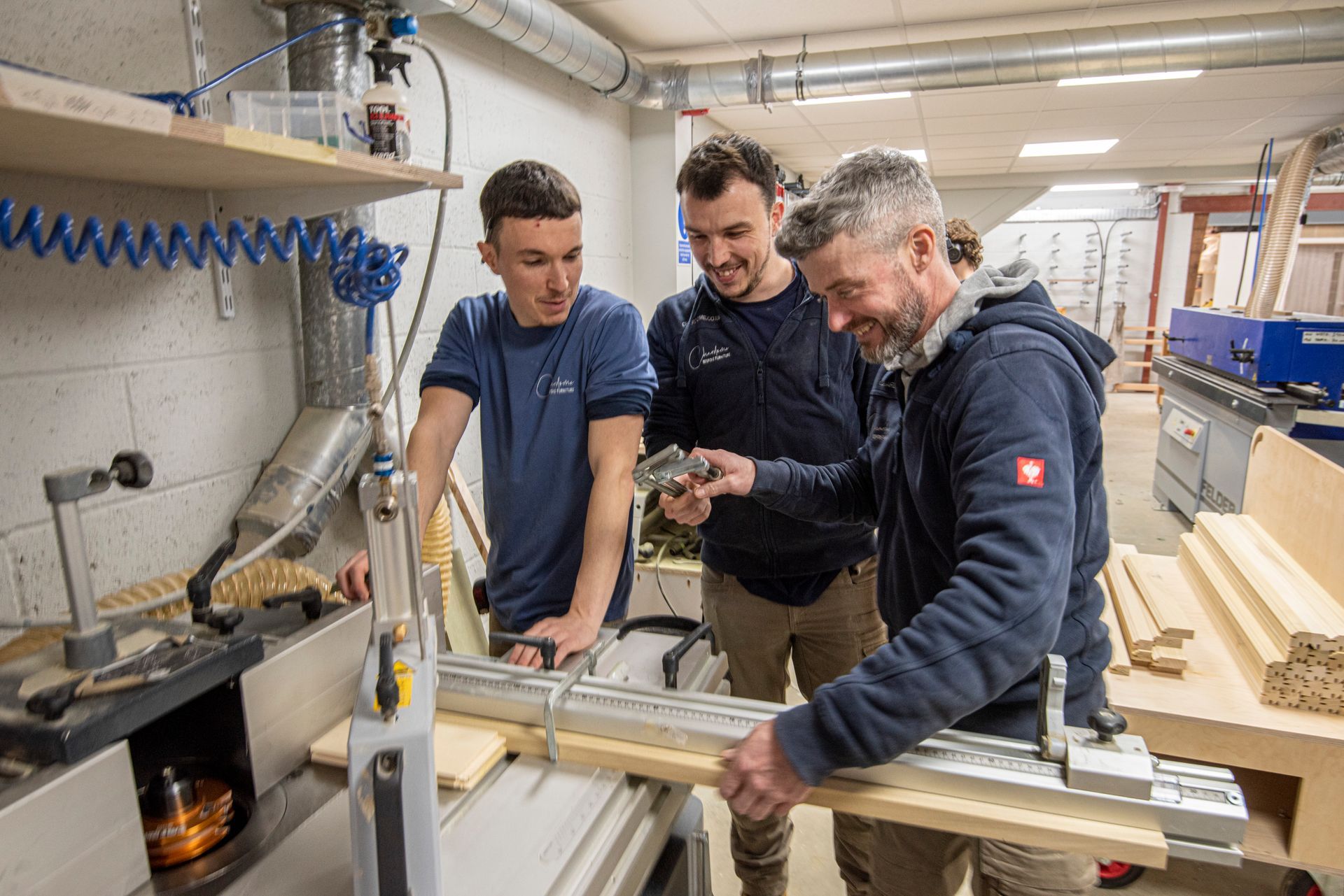 Johnathan, Valentin and a colleague are measuring a piece of wood