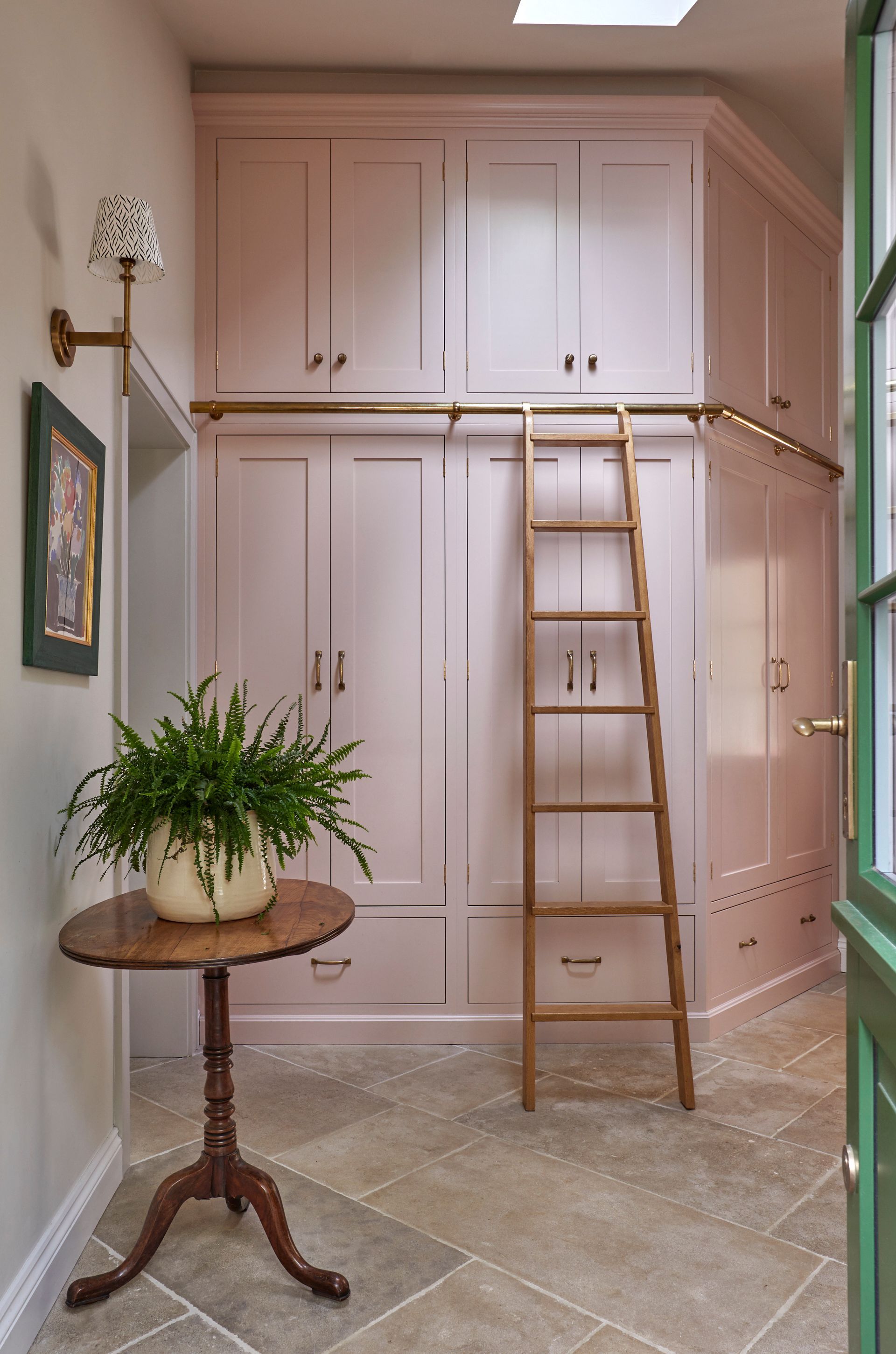 a room with pink cabinets and a wooden ladder