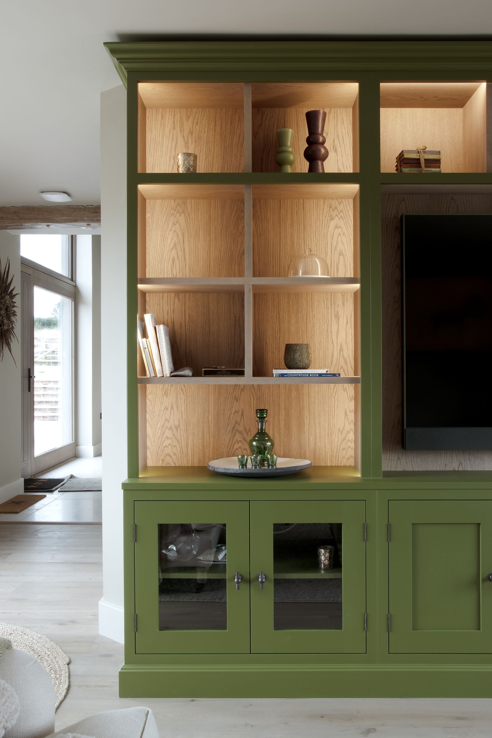a green entertainment center with a custom tv units