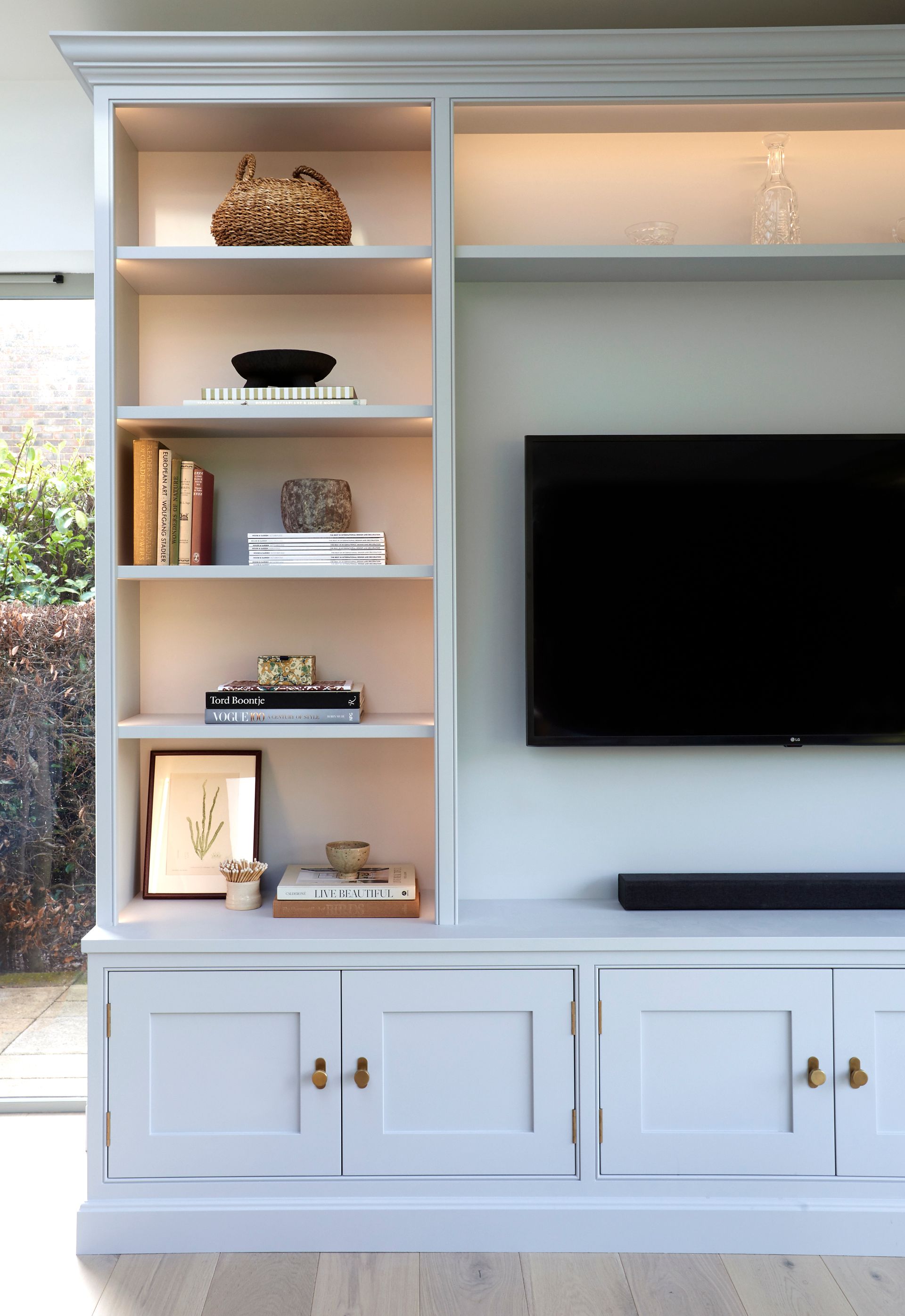 a living room with a built in wall units