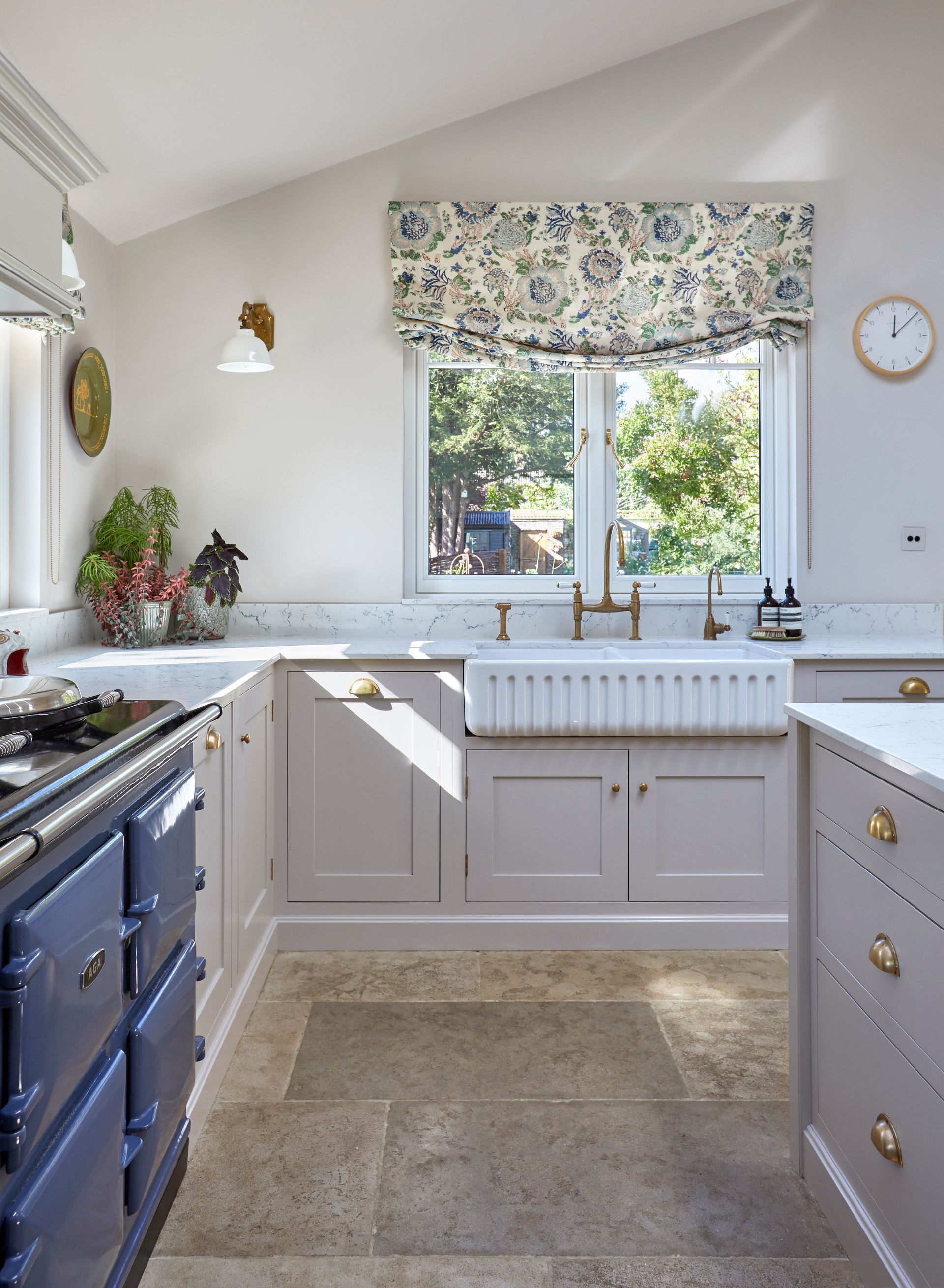 a kitchen with a blue stove and a clock on the wall