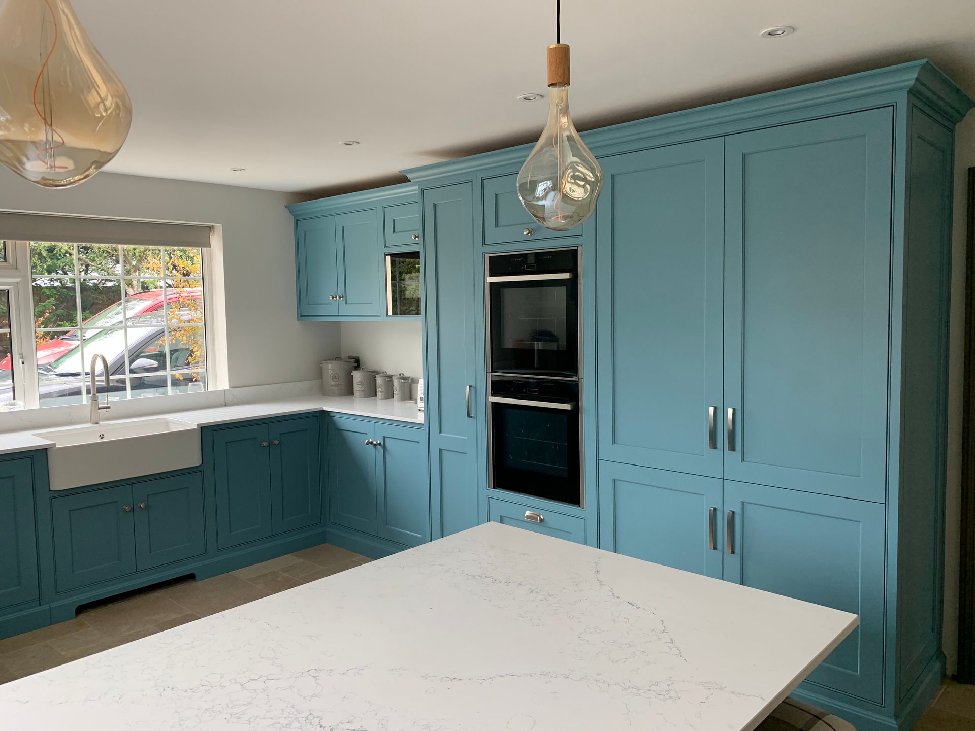 a high end kitchen with blue cabinets and white counter tops