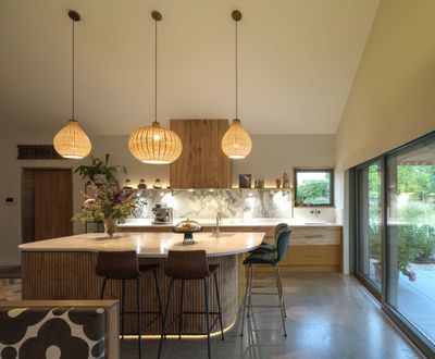 a kitchen with a large island and stools