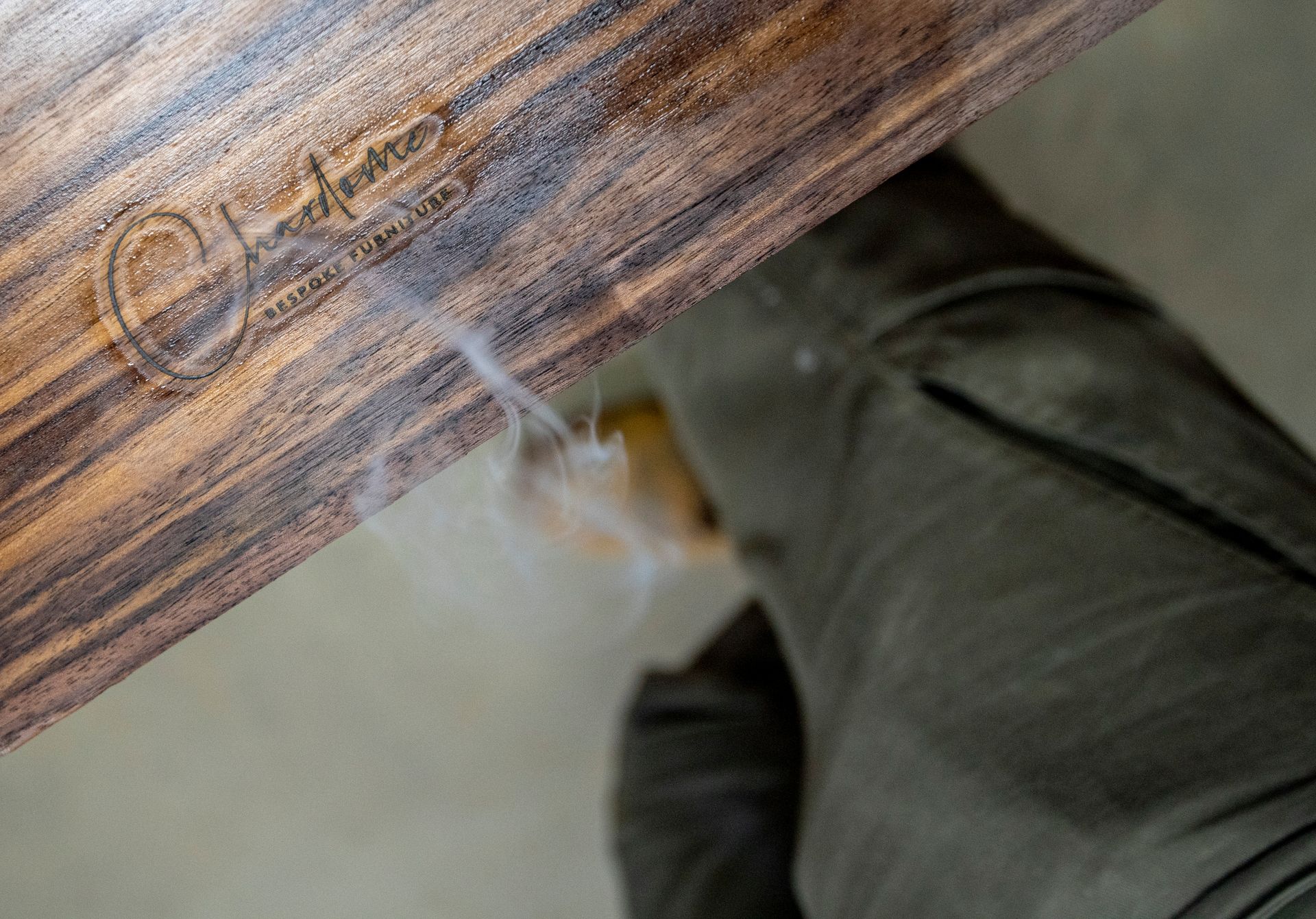 smoke is coming out of a piece of wood that says Chardome on it