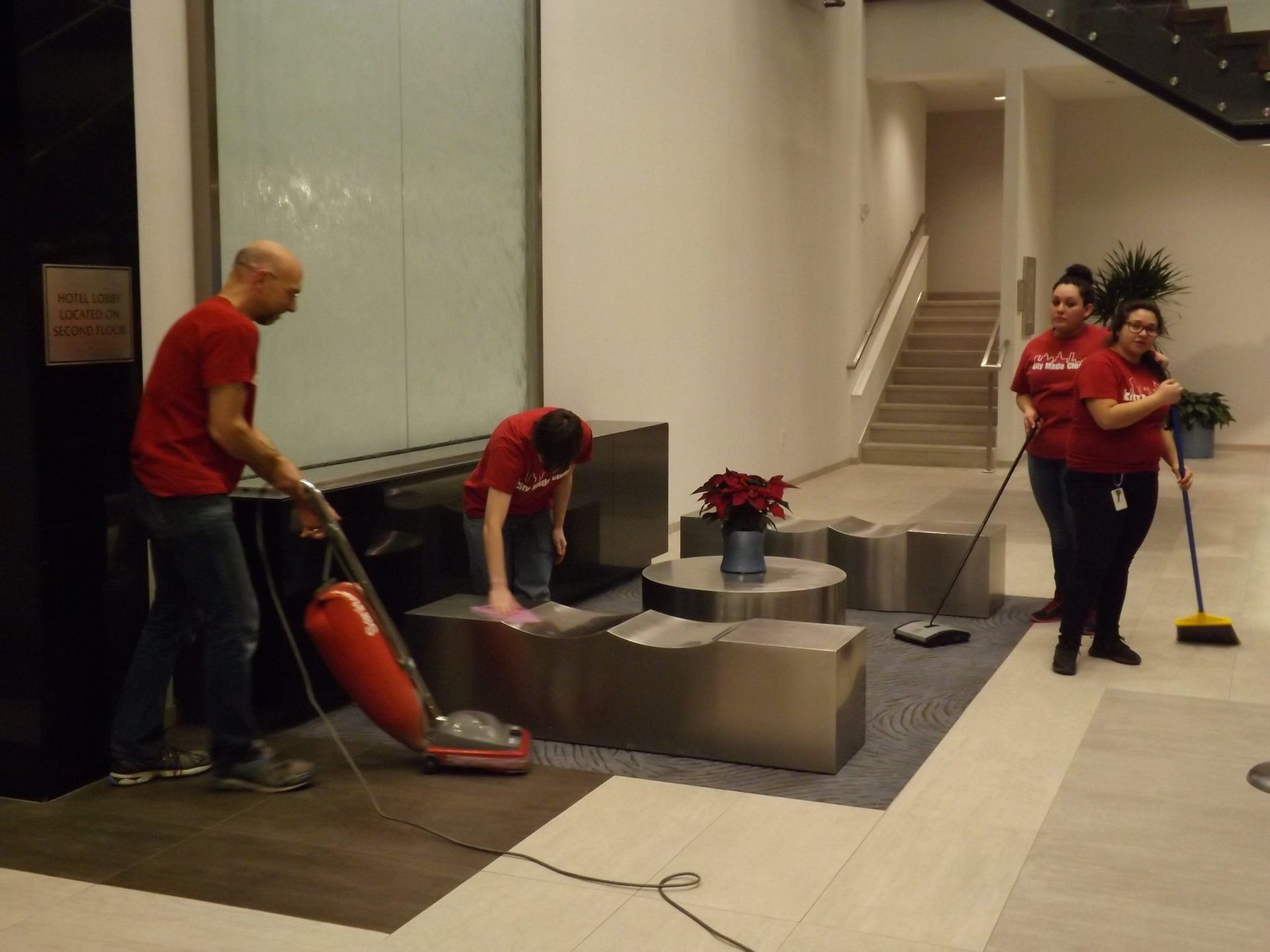 A man is using a vacuum cleaner to clean the floor