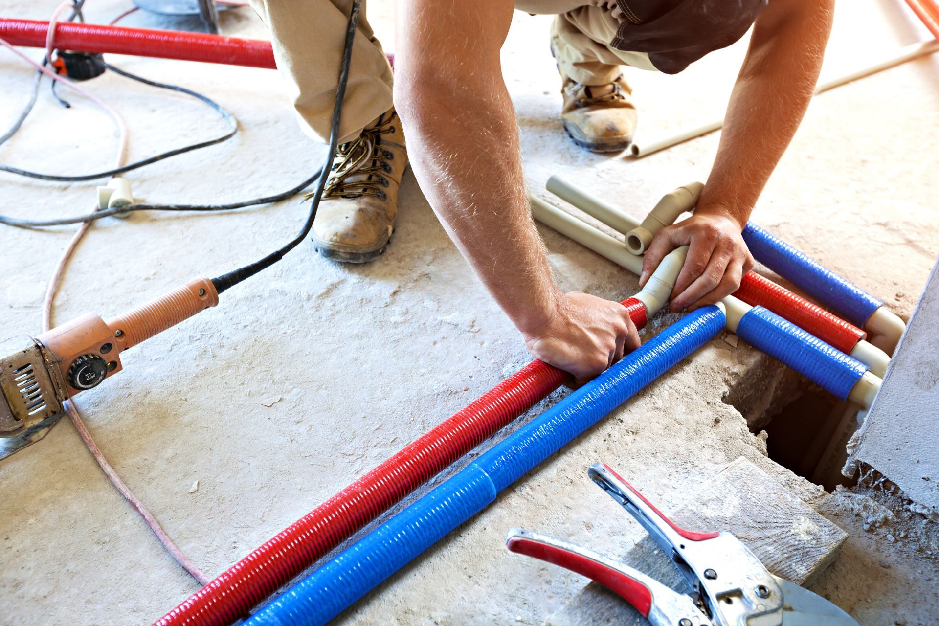 a professional plumber installing new pipes
