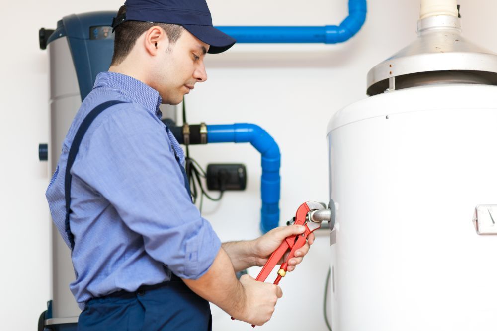 an expert repairing a tank water heater system