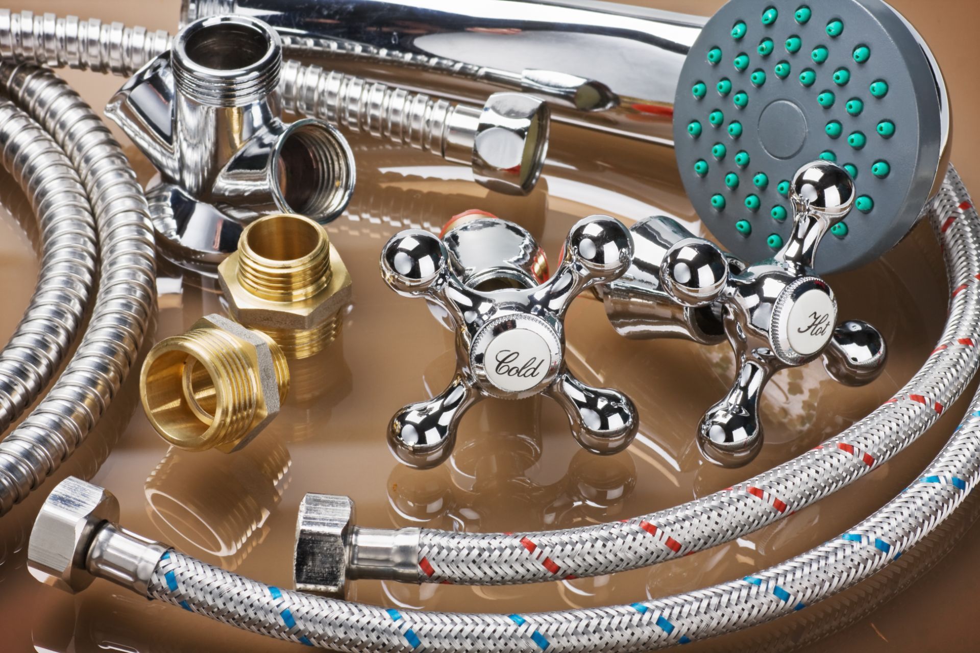 a selection of new pipes, faucets, nuts and bolts, and a shower head