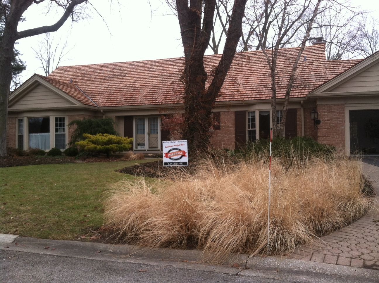 A house with a sign in front of it that says 