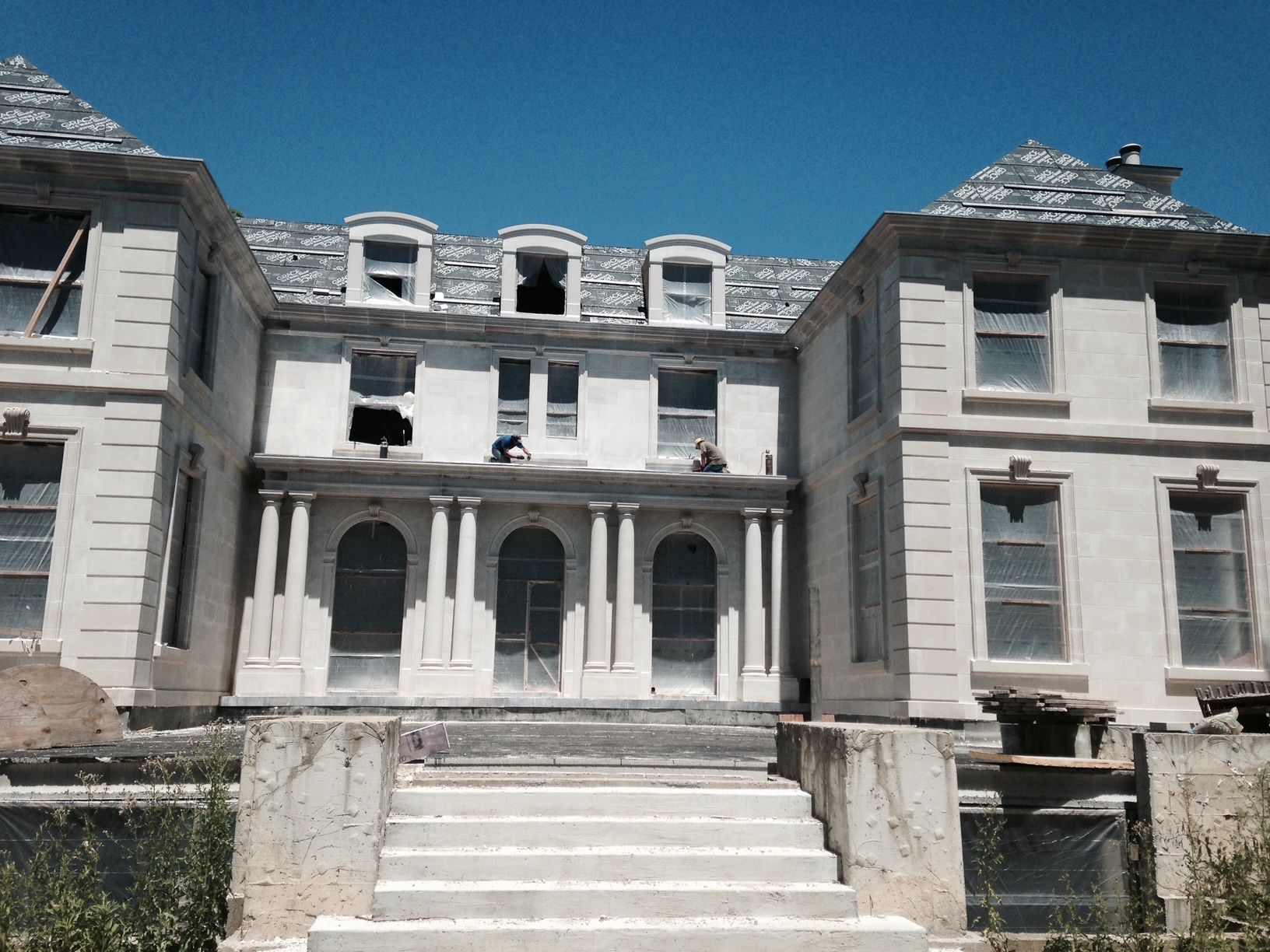 A large white building with stairs leading up to it