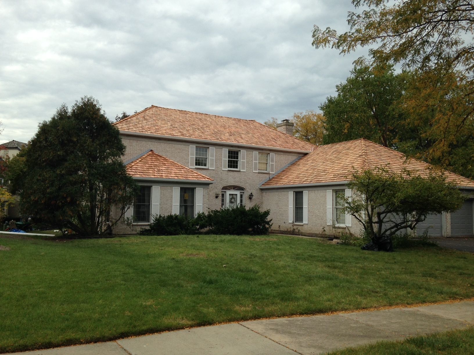 A house with a tiled roof and a lush green lawn