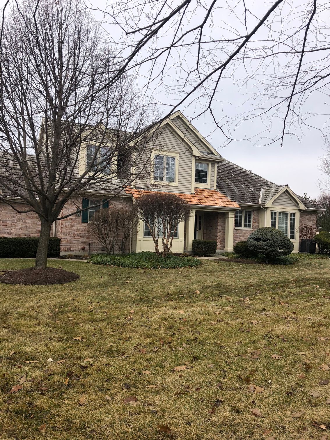 A large house with a large lawn in front of it.