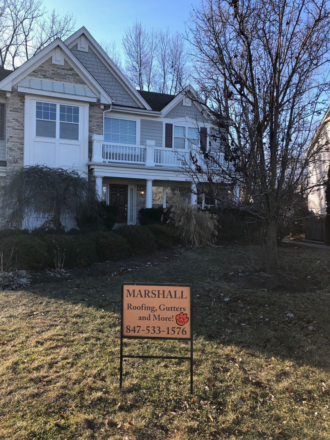 A house with a for sale sign in front of it
