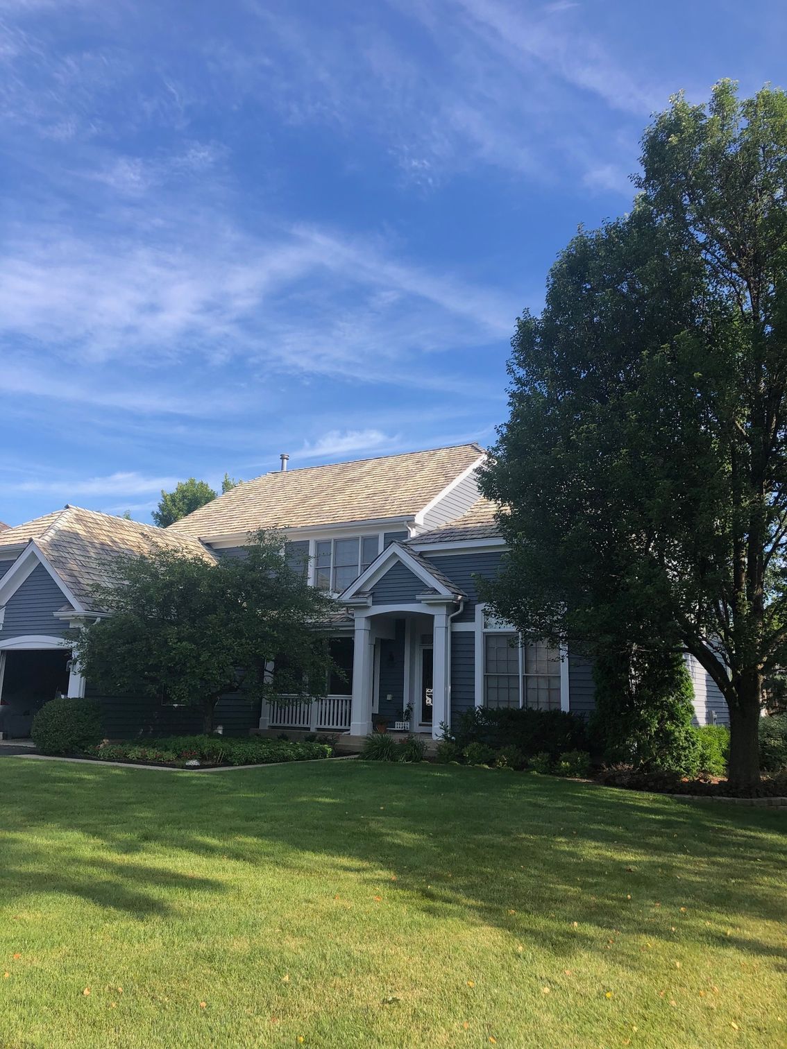 A large house with a large lawn in front of it.